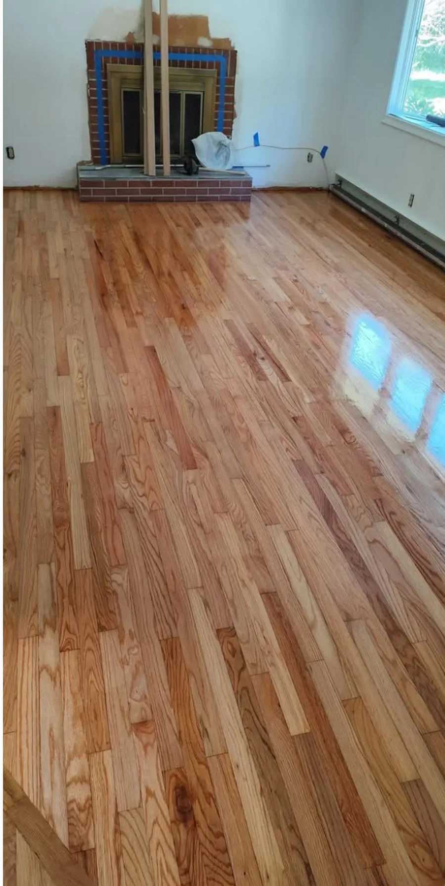 The refinished hardwood floor after sanding and finishing