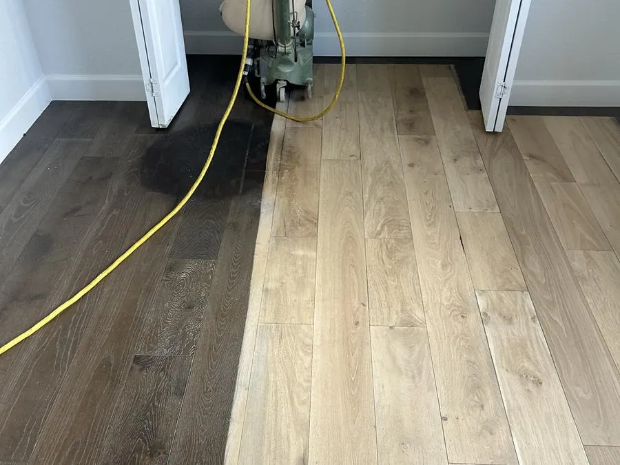 Hardwood floor being sanded back to bare oak